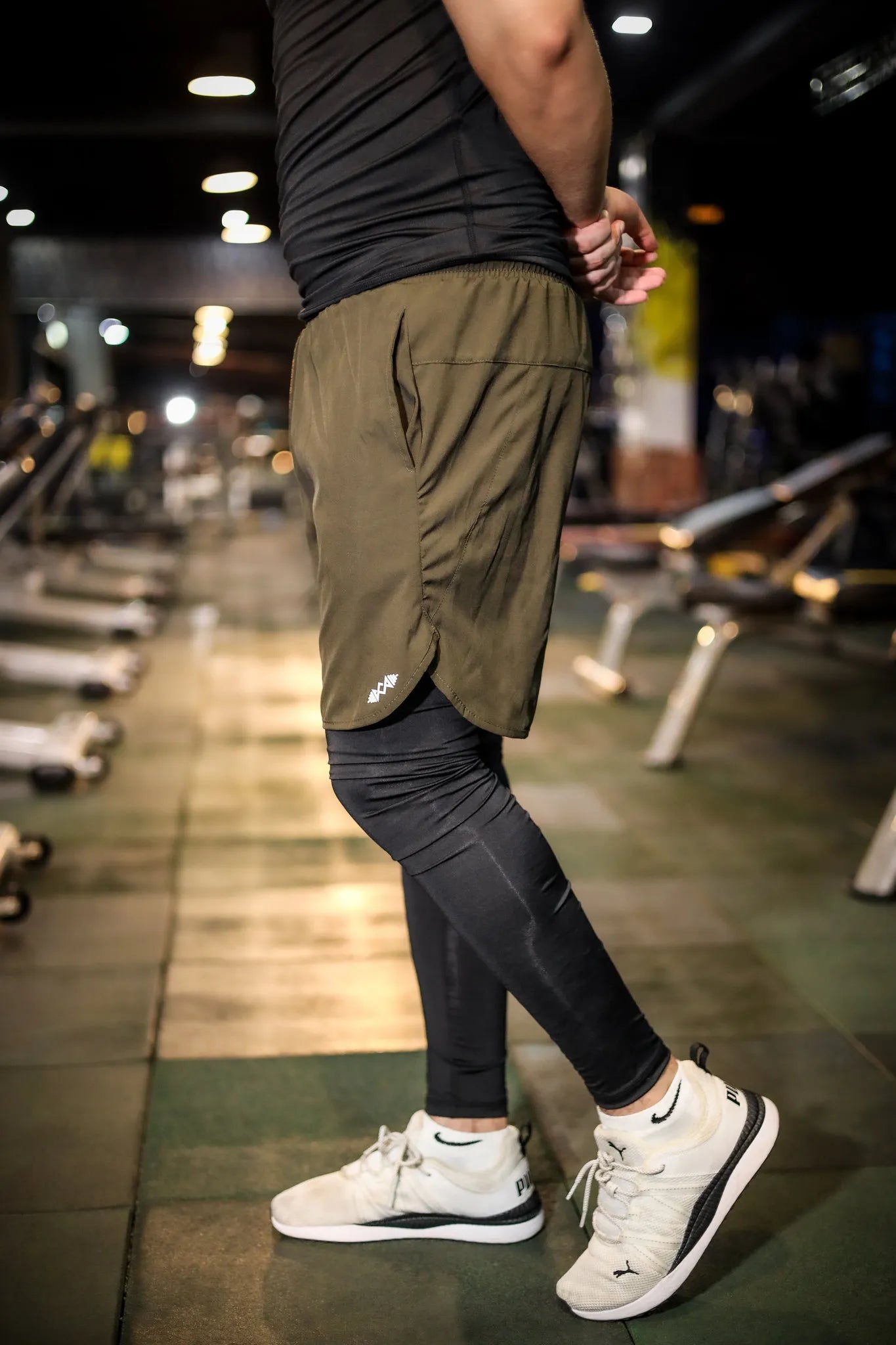 "Men's compression shorts in black and olive green, designed for maximum support and flexibility during workouts and sports. The front view highlights the sleek fit, ensuring comfort and performance in every movement.