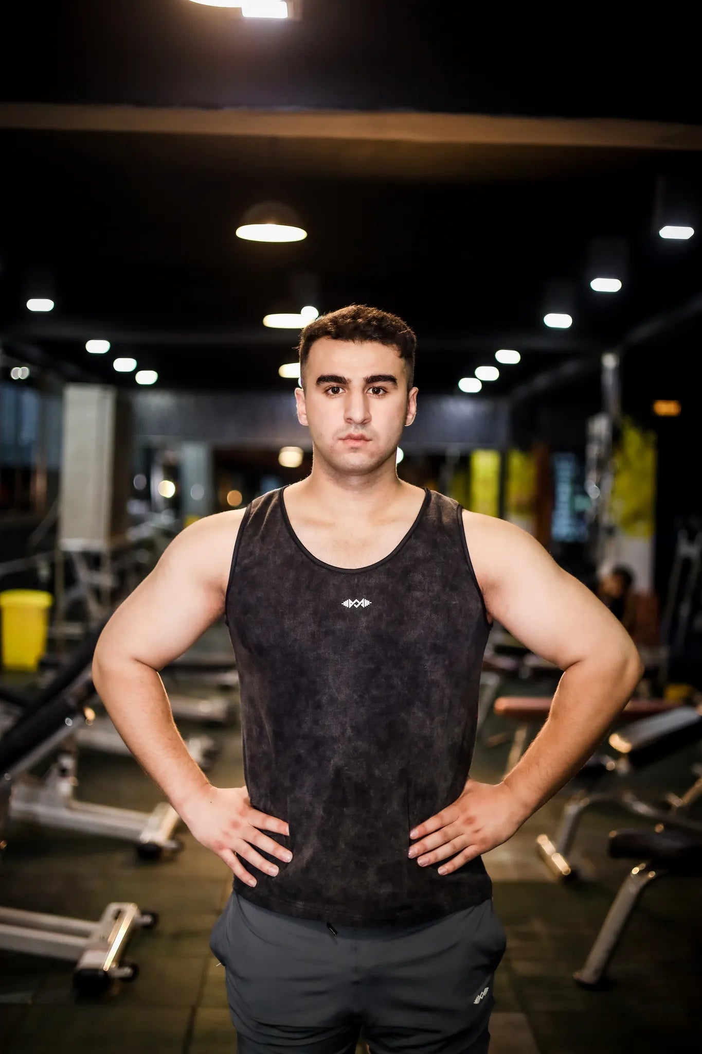 Full view of men's compression tank top in dark black, perfect for intense workouts and sports activities.