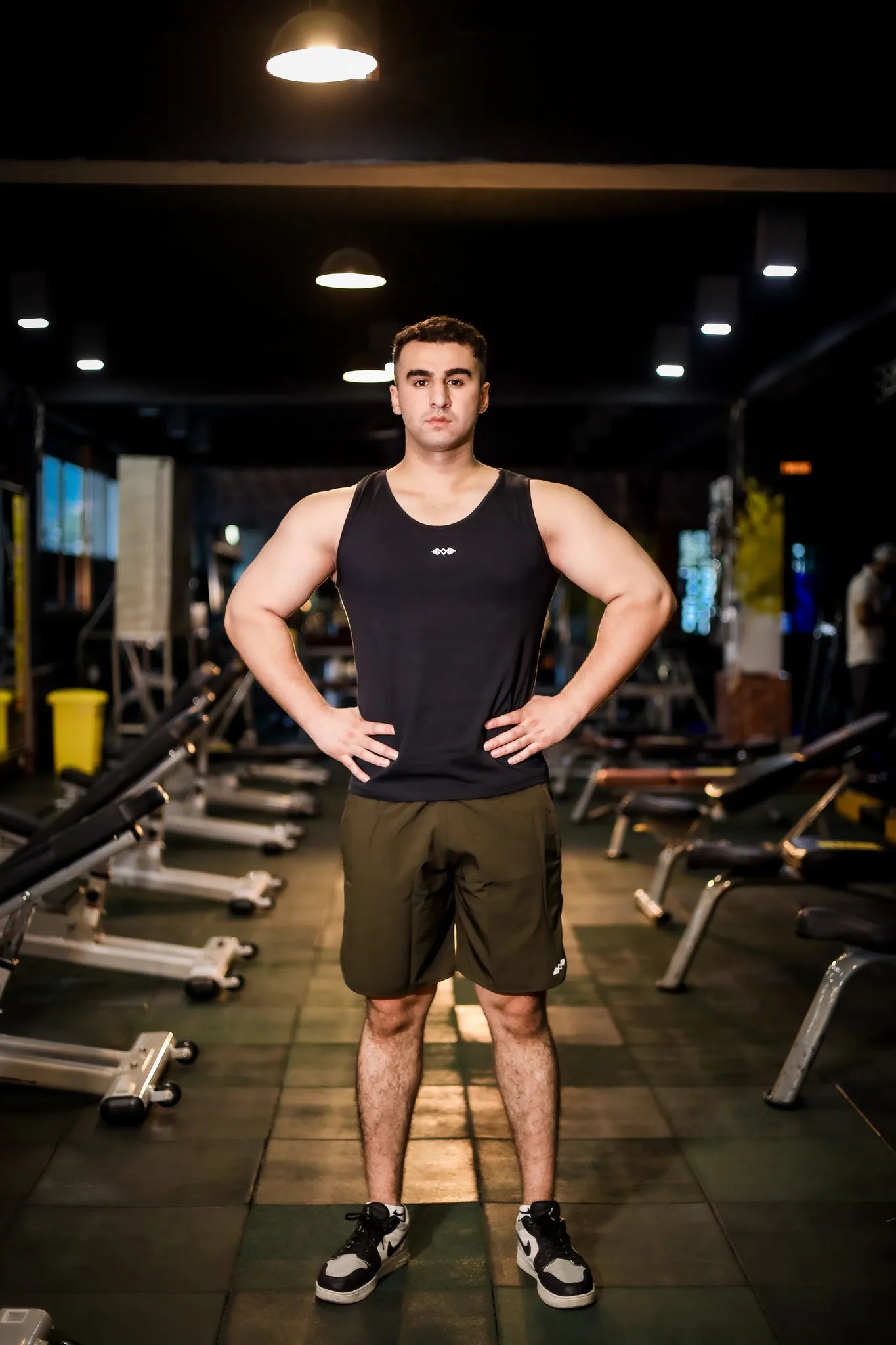 Full view of men's compression tank top in plain black, ideal for gym sessions and casual activities.