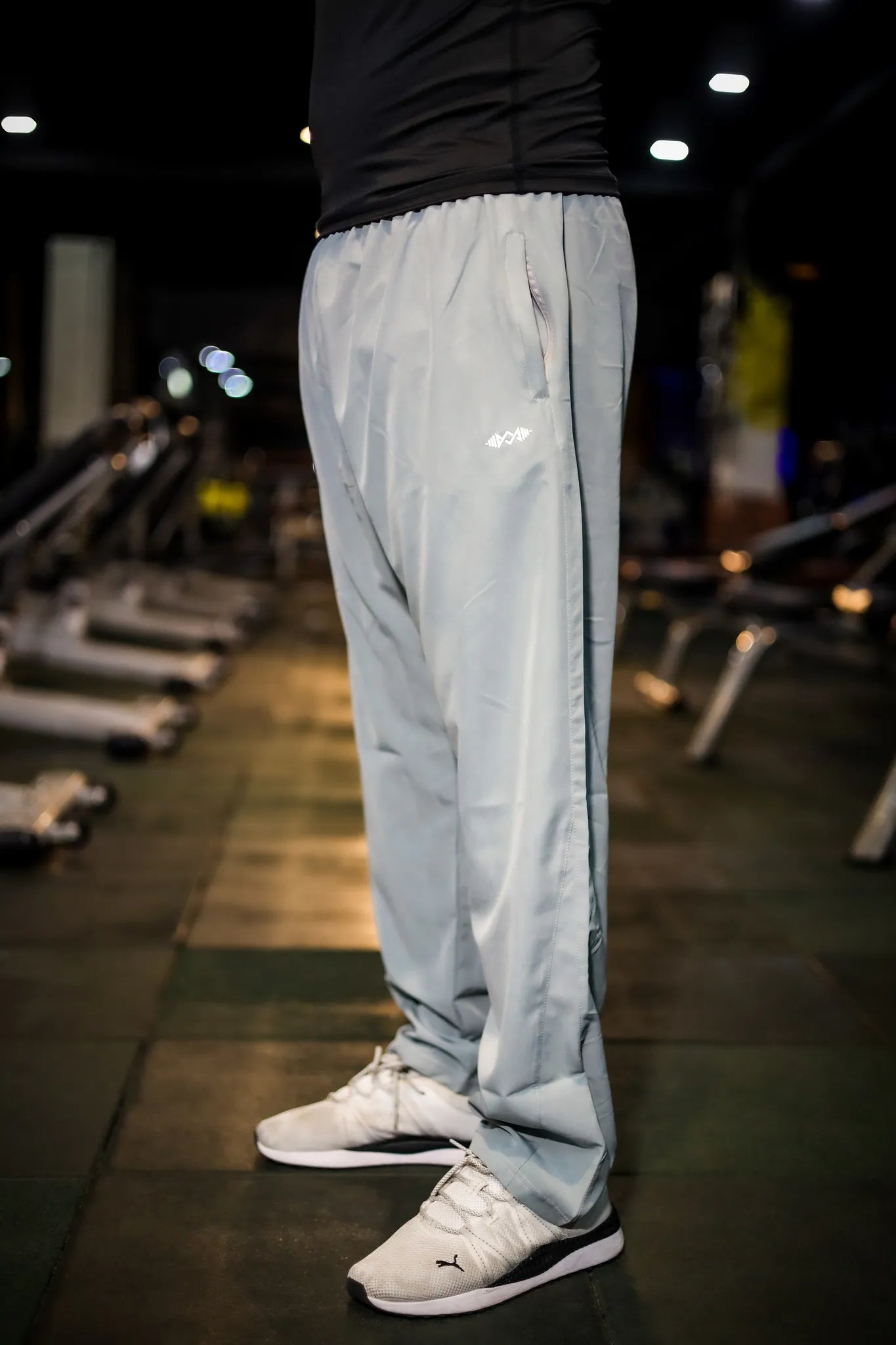 Side view of men's grey losing fit trousers, showcasing comfortable fit and design