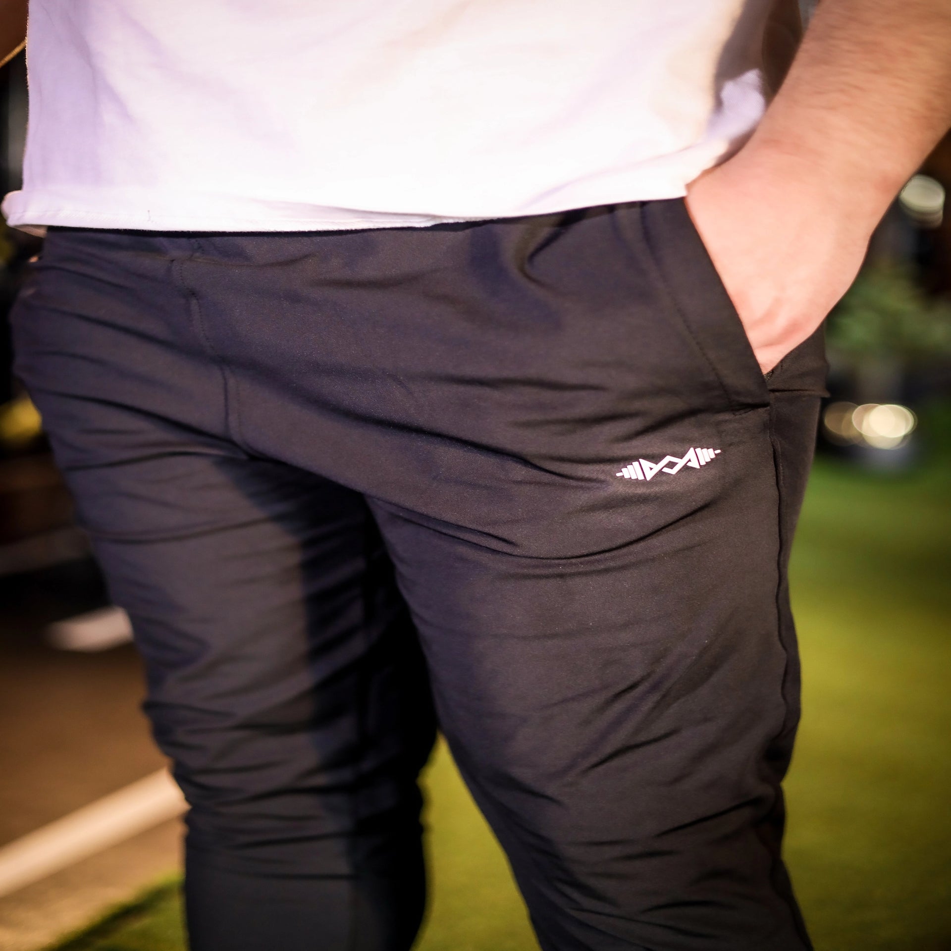 Close-up view of men's black stretch fit trousers highlighting the fabric texture and tailored fit