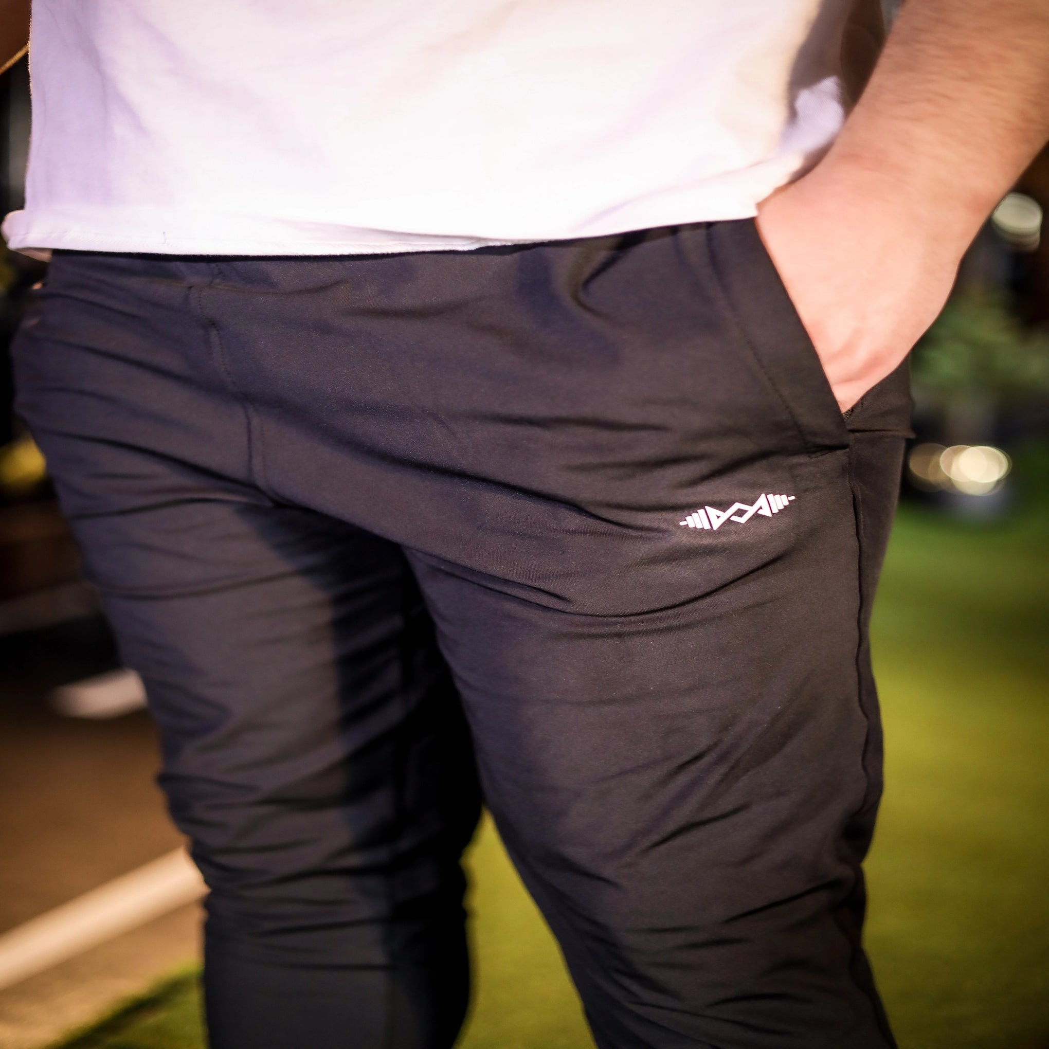 Close-up view of men's black stretch fit trousers highlighting the fabric texture and tailored fit