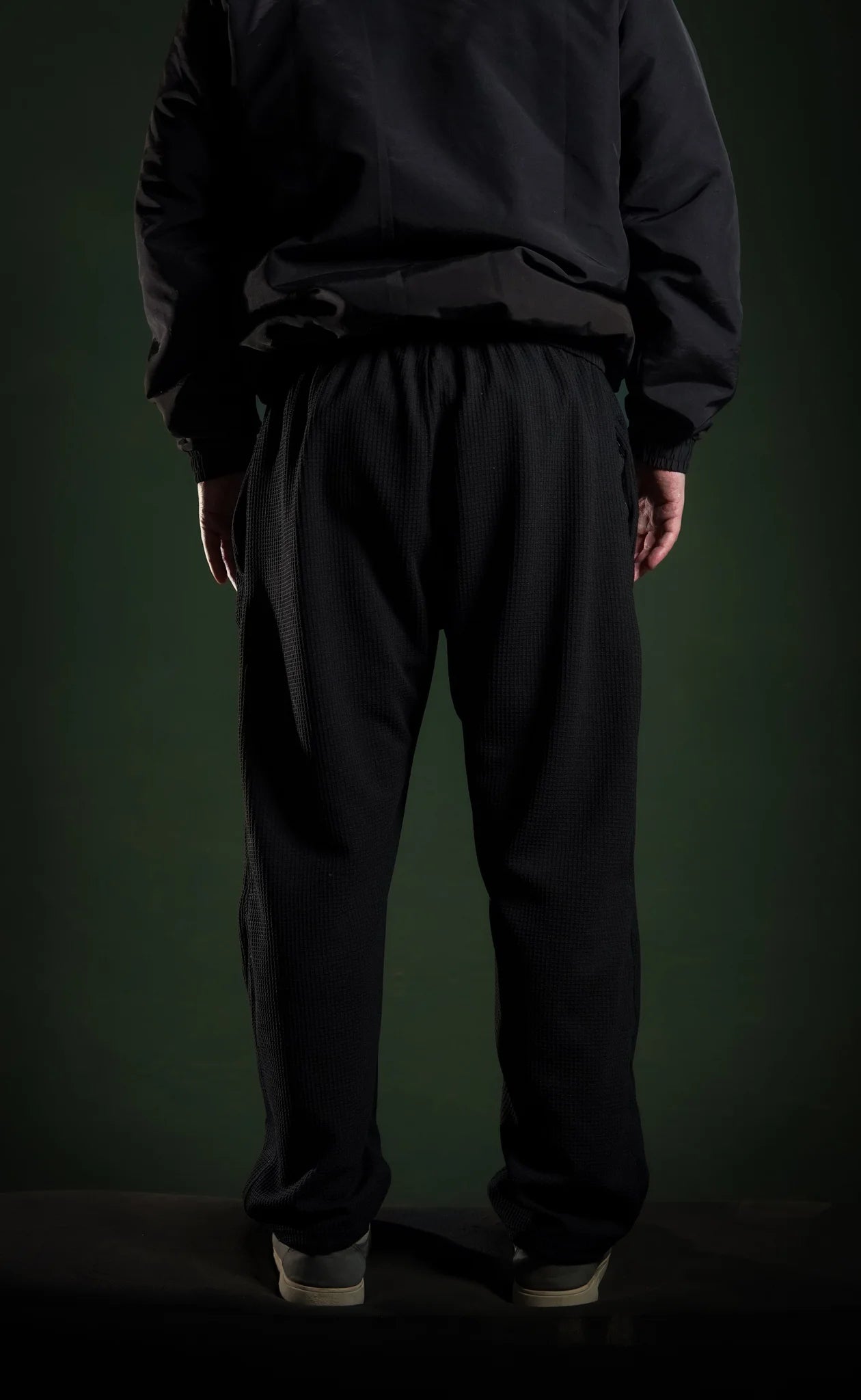 Men’s loose bottom trousers  Black back view. Comfortable and versatile for daily wear