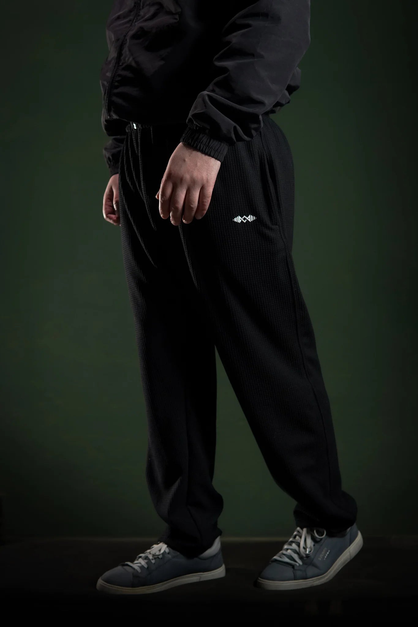 Men’s loose bottom trousers Black side view. Perfect for casual wear and street style