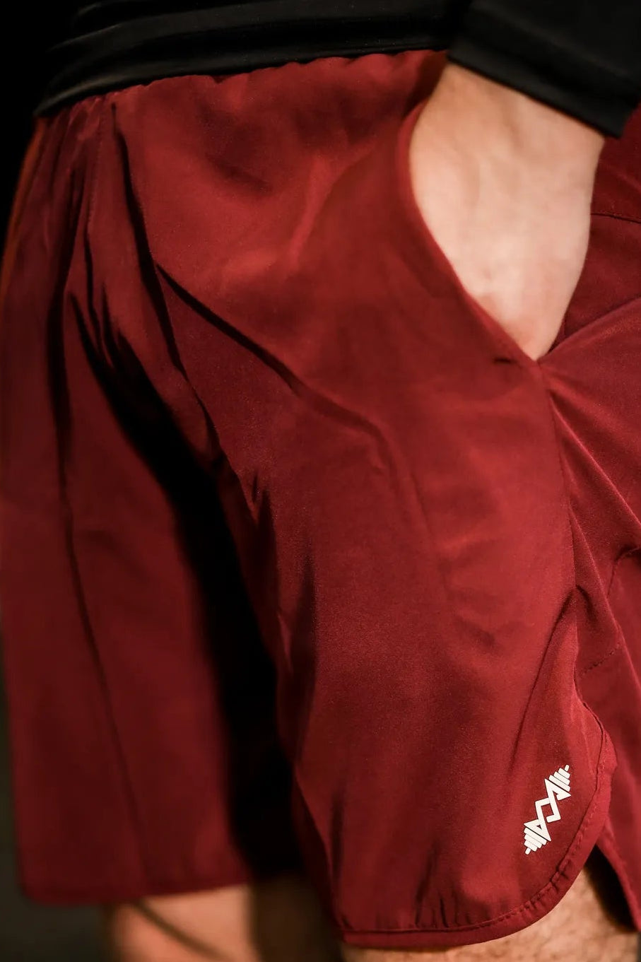 Close-up of the soft, breathable fabric of men's maroon sport shorts, ideal for active wear