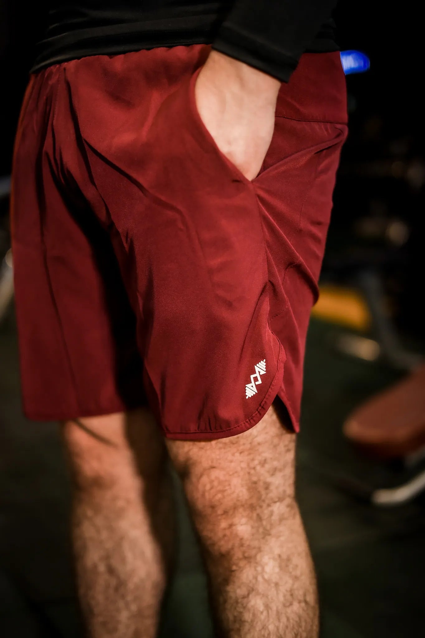 Side view of men's maroon sport shorts, offering a comfortable and flexible fit for active use