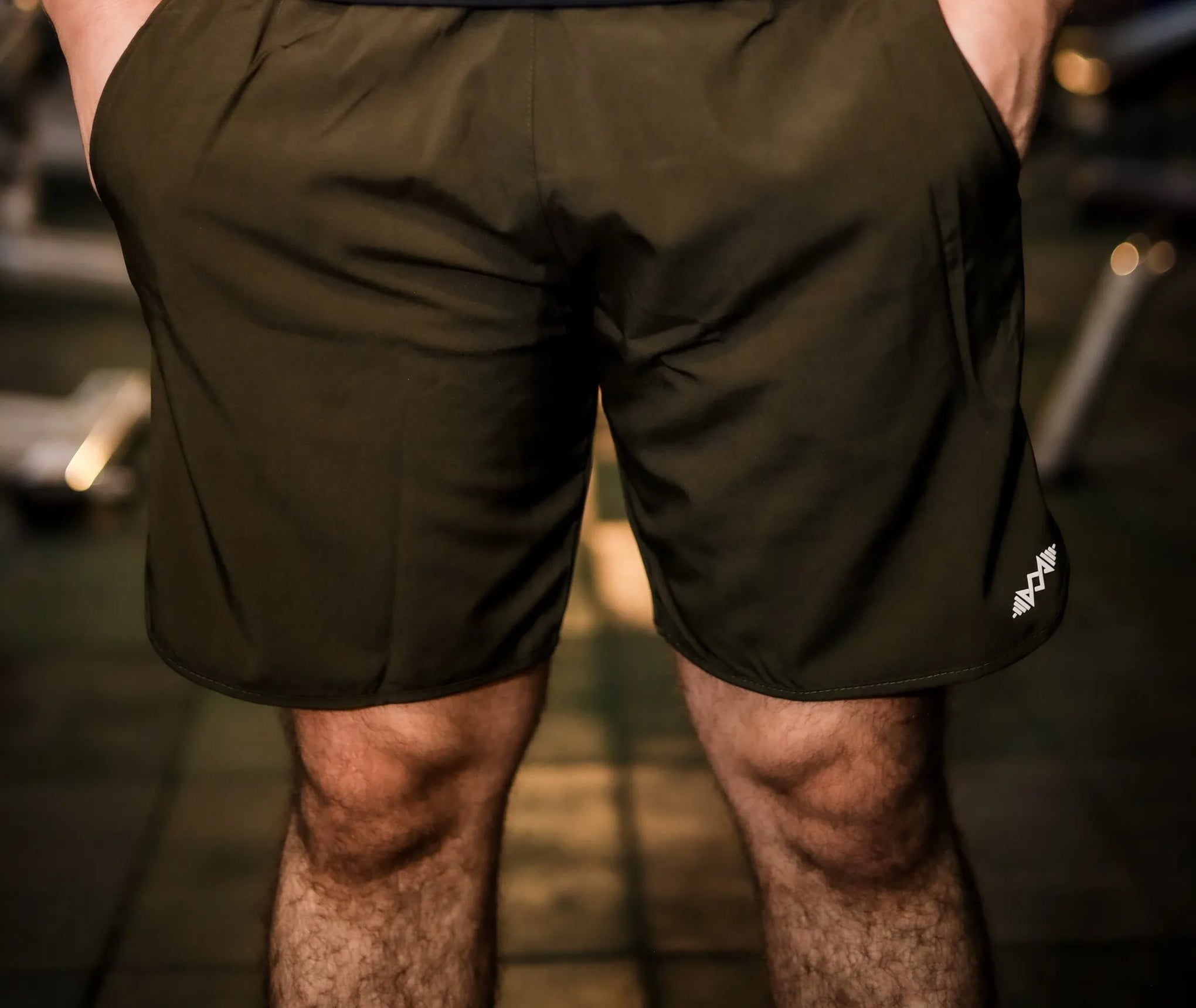 Front view of men's olive green sport shorts, perfect for gym workouts and casual wear