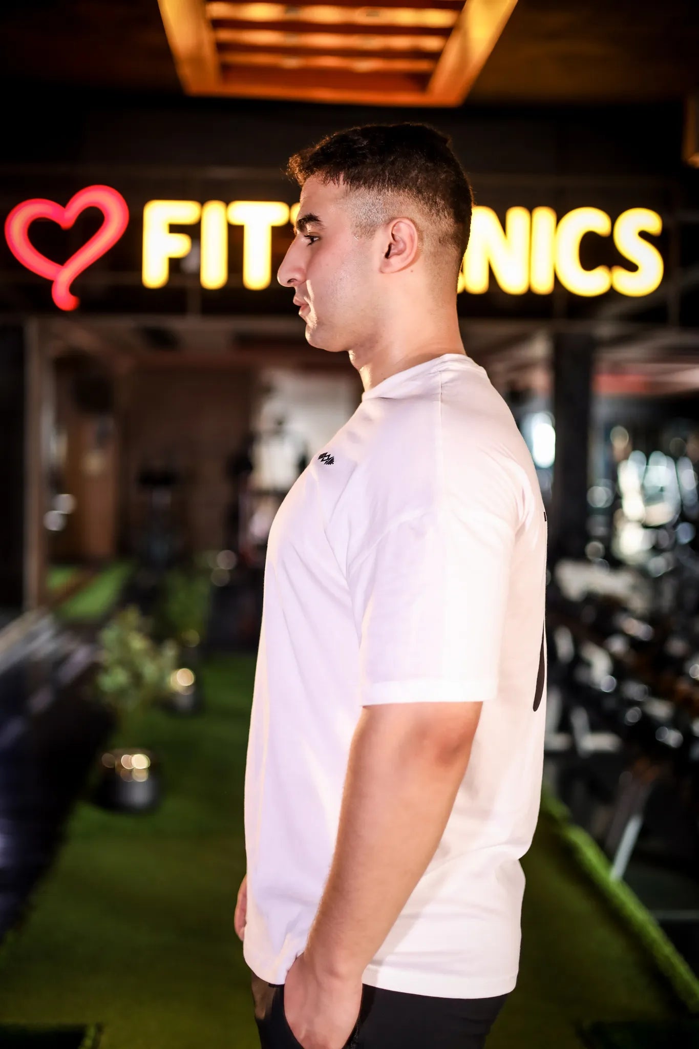 Side view of Murks Drop Shoulder Dripping T-shirt in white, offering a relaxed fit and modern design