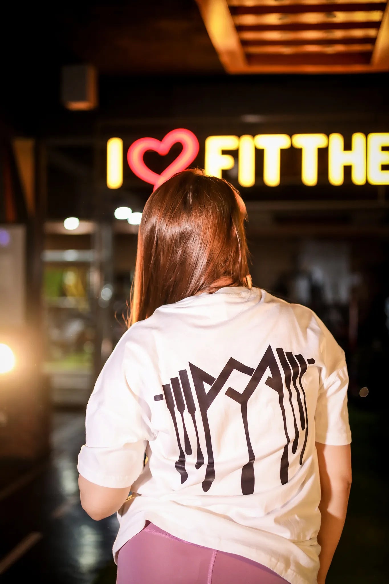 back view of women dripping logo  shirt, perfect for gym and casual wear